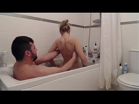 The step-sister entered her brother who was relaxing in the tub and entered with him in the hot water and began to suck his dick then he fucked her and gave cum on her face.